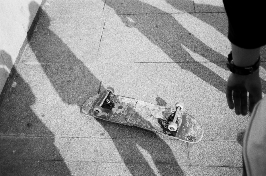 Grayscale Photo of Up-side-down Skateboard